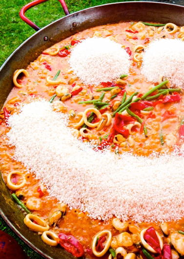 image of a smiling paella